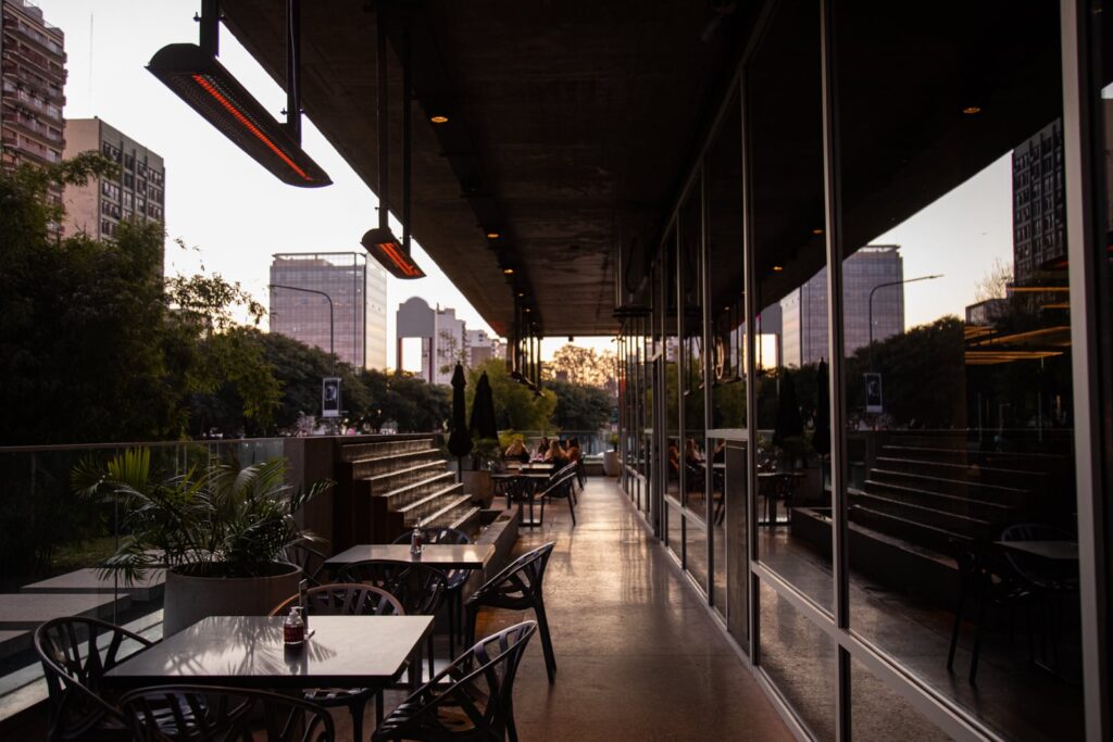 Dusk view of an outdoor restaurant area, dimly hit with Bromic heaters